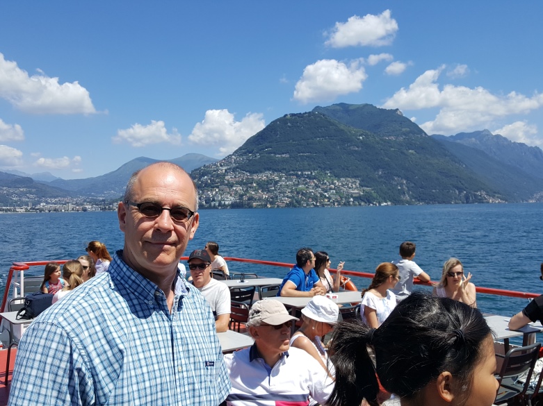 Grant onboard with view of Monte Bre from mid-lake Lugano